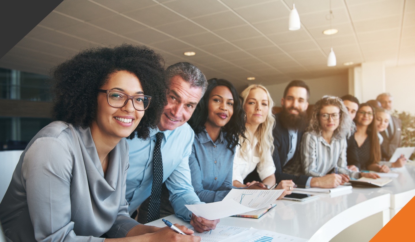 Employees standing at a counter smiling and feeling empowered